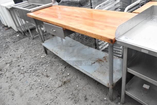 Butcher Block Table with drawer and under shelf, metal legs, wooden top, slightly worn, suitable for kitchen or workshop.