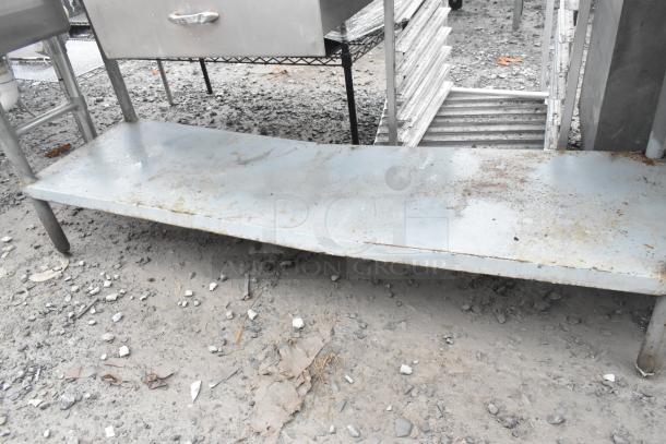 Large metal table with visible wear and rust, featuring a drawer and an under shelf; appears to need cleaning.