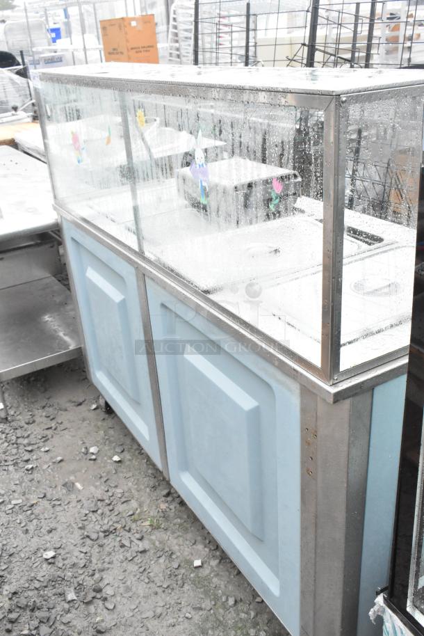 Delfield SE-H4 stainless steel steam table with cracked glass. 120/208 volts, 1 phase. Visible wear on exterior.