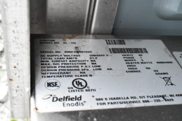 Delfield SE-H4 stainless steel steam table label showing model and specs. Crack in glass mentioned. 120/208V, 1 phase.