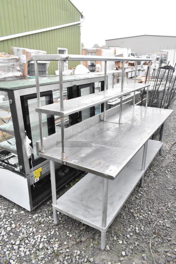 Stainless steel table with under shelf and 2-tier over shelf, in used condition, ideal for commercial kitchens.