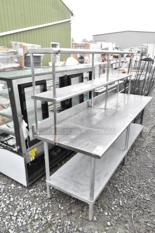 Stainless steel table with under shelf and 2-tier over shelf, in used condition, ideal for commercial kitchens.