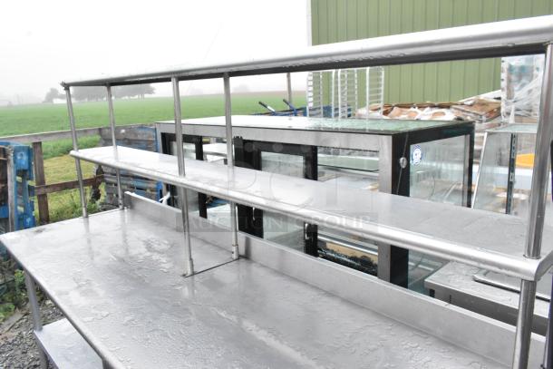 Stainless steel table with under shelf, two-tier over shelf; durable, weather-resistant, ideal for outdoor use or kitchens.