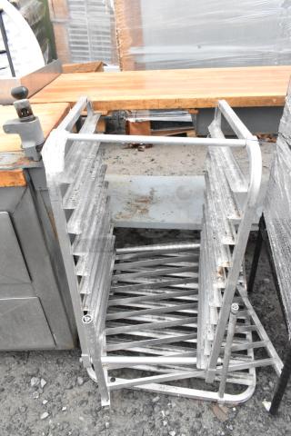 Metal pan rack with multiple slots, showing signs of wear and minor rust. Ideal for kitchen storage and organization.