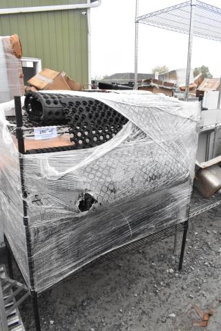 Black finish 3-tier wire shelving unit with contents and floor mat, wrapped in plastic, buyer must dismantle.