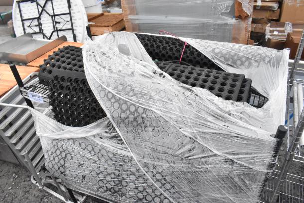 Black finish 3-tier wire shelving unit with contents and floor mat. Wrapped for shipping; buyer must dismantle. Consider freight.