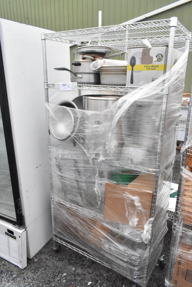 Chrome finish 5-tier wire shelving unit with metal drop-in bins, secured with plastic wrap, requires buyer dismantling.