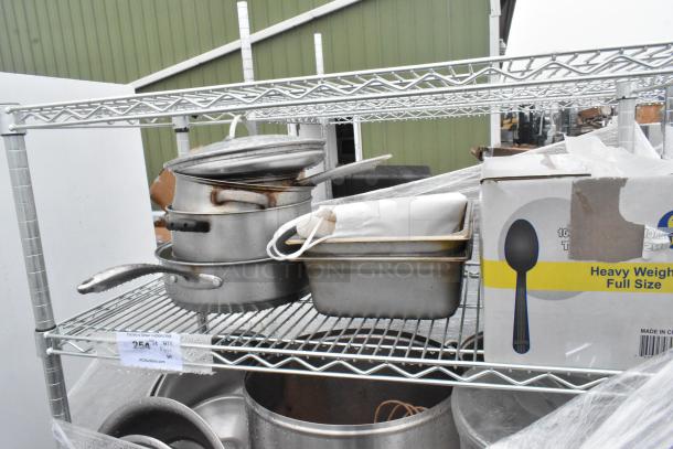 Chrome finish 5-tier wire shelving unit with metal drop-in bins, includes various cookware. Buyer must dismantle for shipping.