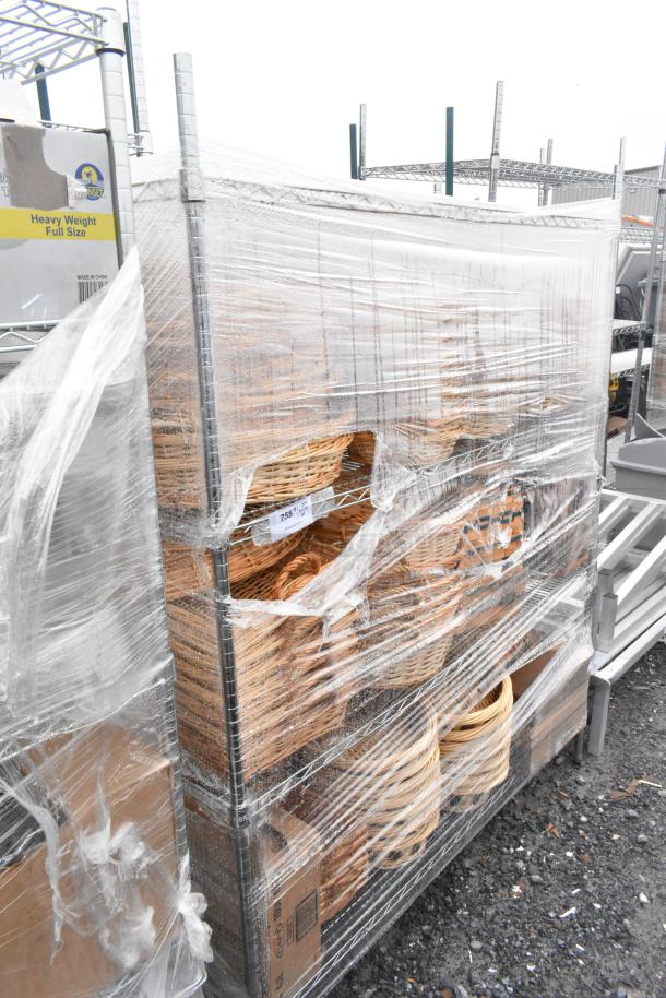 Chrome finish 4-tier wire shelving unit with baskets, wrapped in plastic. Buyer must dismantle; freight required.