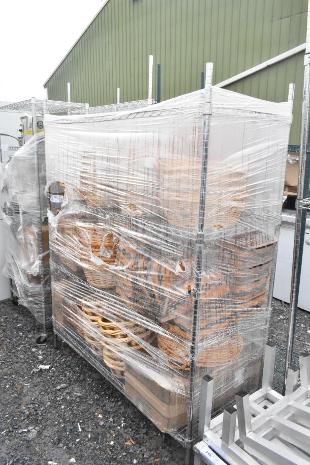 Chrome finish 4-tier wire shelving unit with baskets, wrapped for shipping. Buyer must dismantle. Consider freight charges.