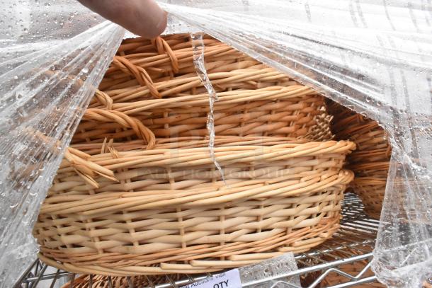 Chrome finish 4-tier wire shelving unit with wicker baskets, covered in clear plastic. Buyer must dismantle for shipping.