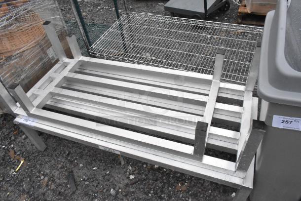 Five metal dunnage racks, stackable, used condition, slatted design, sturdy construction, various sizes. Auction item #257.