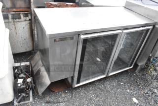 True TBB-2G-S metal commercial back bar merchandiser with two glass doors, 115 volts, and 1 phase. Used condition.