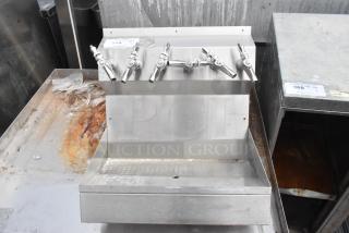 Stainless steel 6 tap dispenser, features six stainless taps, sturdy construction, slight surface rust and wear, ideal for bar use.
