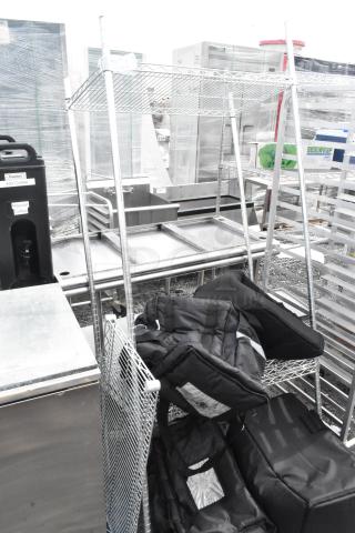 Chrome finish shelving unit with stainless steel drop-in bins on commercial casters, includes padded bags and containers.