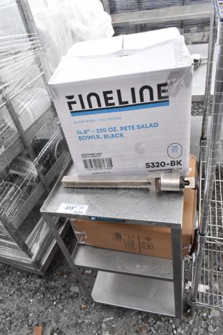 Metal 3-tier cart with commercial can opener and boxed contents. Top box marked "Fineline" for 320 oz. PETE salad bowls. Minor wear visible.