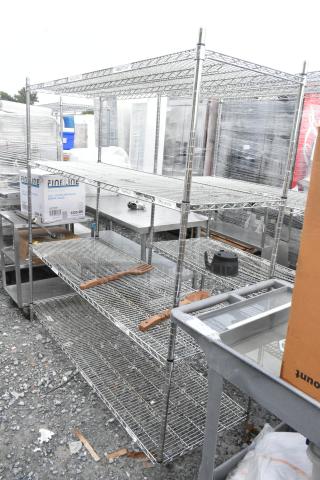 Chrome finish 4-tier wire shelving unit in used condition. Buyer must dismantle. Consider freight charges for shipping.