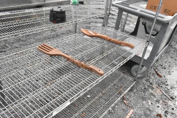 Chrome finish 4-tier wire shelving unit in used condition. Includes wood spatula and fork. Buyer must dismantle for shipping.