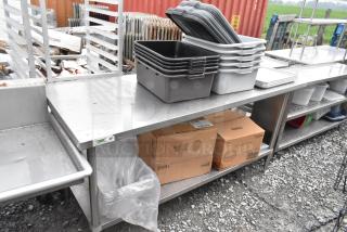 Regency 600TS3072S stainless steel table with under shelf, includes poly bus bins, boxes, and other contents.