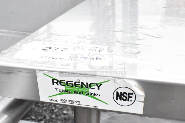 Regency 600TS3072S stainless steel table with an under shelf, includes poly bus bins. Features NSF label, good condition.