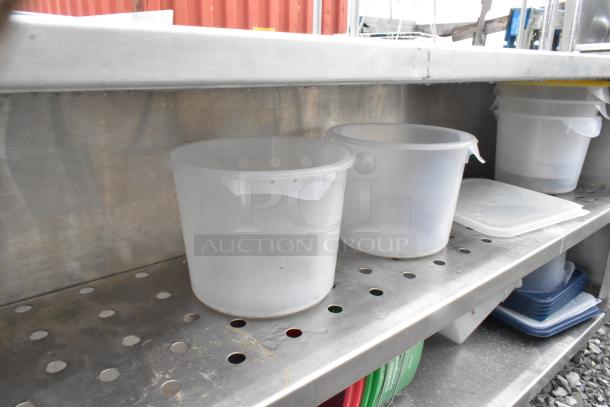 Stainless steel table with two metal under shelves, featuring a perforated design. Used condition, ideal for storage.