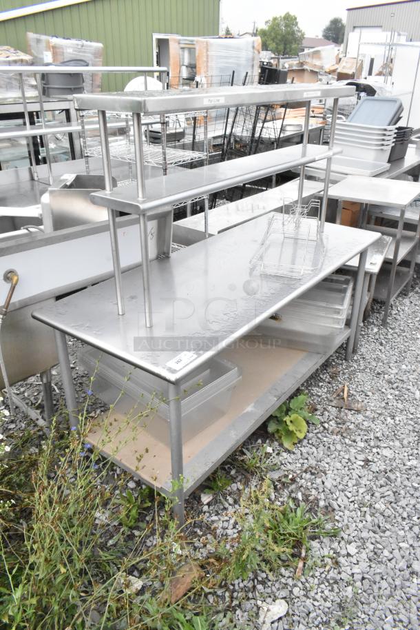 Stainless steel table with metal under shelf and 2-tier over shelf. Used condition, suitable for kitchen or industrial use.