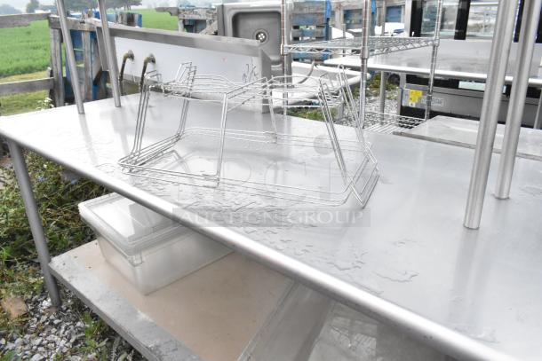 Stainless steel table with a metal under-shelf and 2-tier over-shelf, featuring a durable surface and sturdy design.