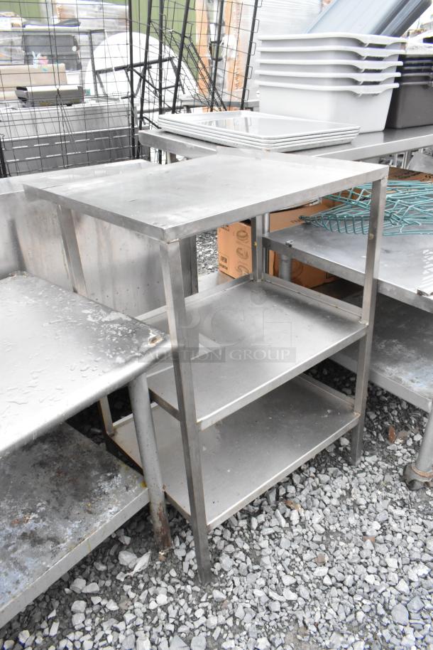 Metal 3 tier unit with sturdy shelves, used condition, suitable for storage or industrial use, visible wear and rust.