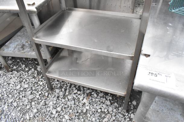 Metal 3-tier storage unit with a stainless steel finish. Visible scuffs and marks indicate moderate wear.