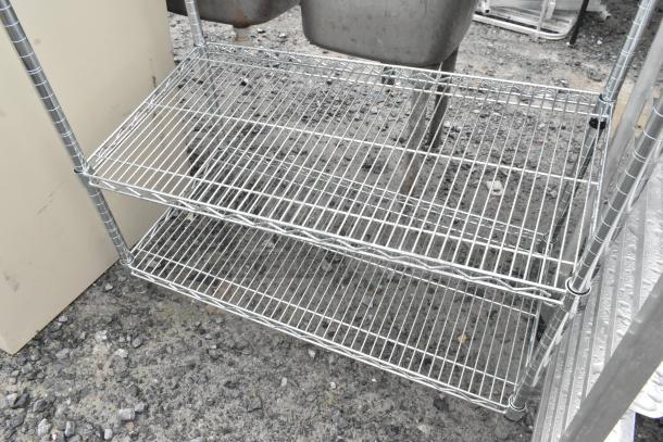 Chrome finish 4-tier wire shelving unit. Requires buyer dismantling for collection. Consider freight charges.