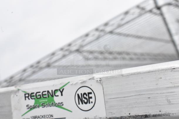 Regency metal pan transport rack with commercial casters, NSF certified. Visible brand label.