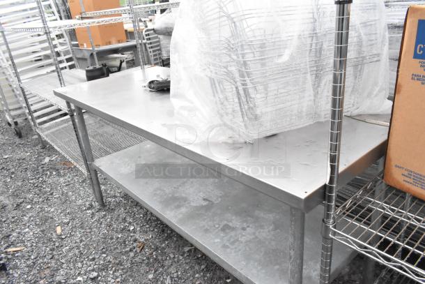 Stainless steel table with metal under shelf. Appears in used condition with some surface wear. Ideal for industrial use.