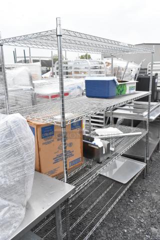 Chrome finish 4-tier wire shelving unit with contents, featuring a durable metal frame. Buyer must dismantle.