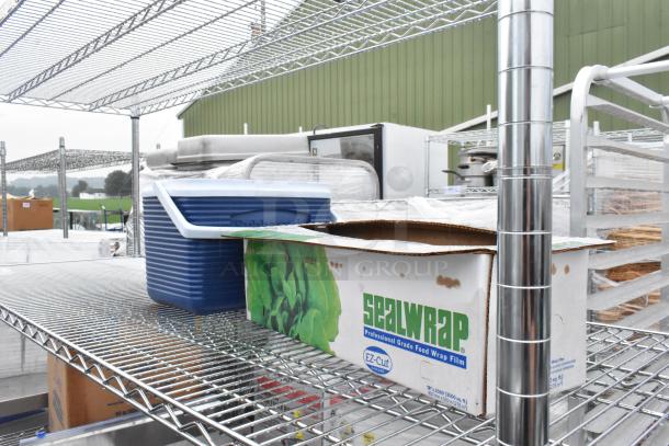 Chrome finish 4-tier wire shelving unit with contents. Includes boxes and containers. Buyer must dismantle for shipping.