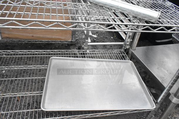 Chrome finish 4-tier wire shelving unit with contents, sturdy construction, buyer must dismantle. Consider freight charges.