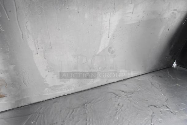 Stainless steel tabletop with visible water stains and blemishes, industrial finish, suitable for commercial use.