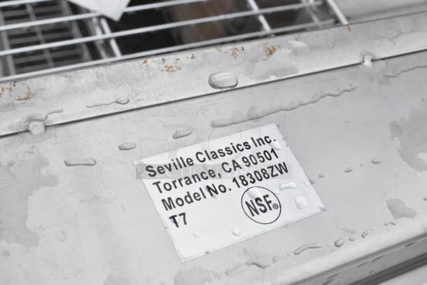 Seville Classics stainless steel tabletop with visible NSF certification label, model 18308ZW, in used condition.