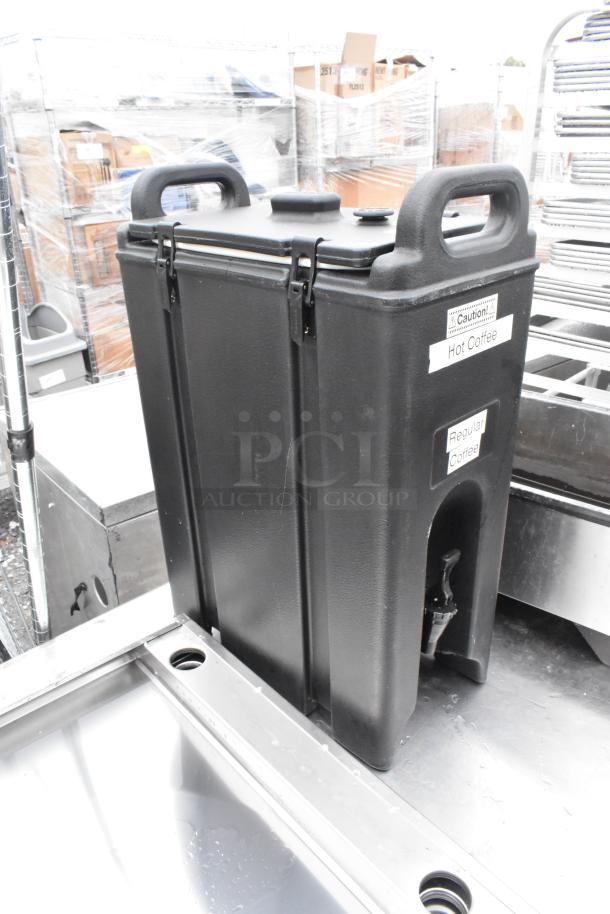Cambro Black Poly Beverage Dispenser with handles, spigot, and "Hot Coffee" and "Regular Coffee" labels, in good condition.