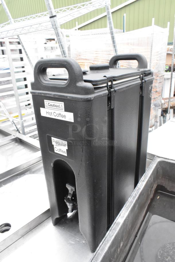Cambro black poly beverage dispenser with carrying handles and spout, labeled for hot and regular coffee; in good condition.