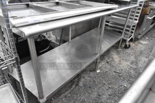 Stainless steel table with under shelf, used condition. Smooth surface, sturdy legs, ideal for commercial kitchens.