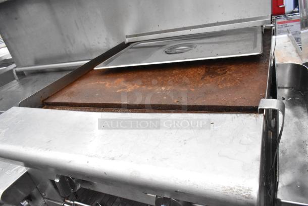 American Range stainless steel gas-powered 6-burner commercial range with flat top griddle, 2 ovens, overshelf, and backsplash.