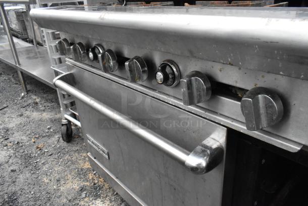 American Range stainless steel commercial gas range, 6 burners, right-side flat top griddle, 2 ovens, over shelf, back splash.