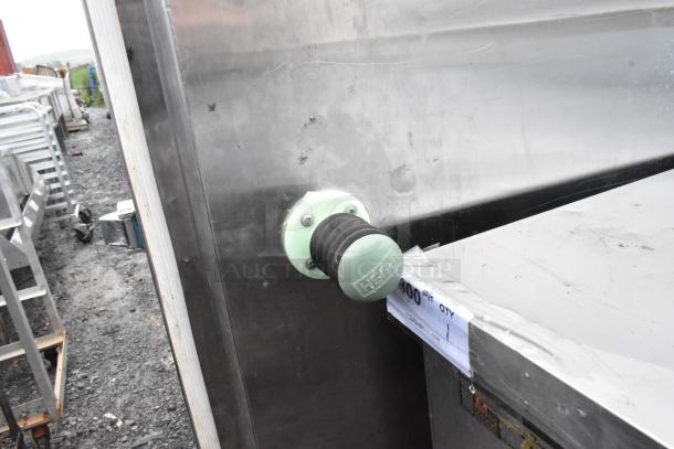Stainless steel door with visible handle and latch, showing slight wear. Auction tag displays quantity and auction website details.