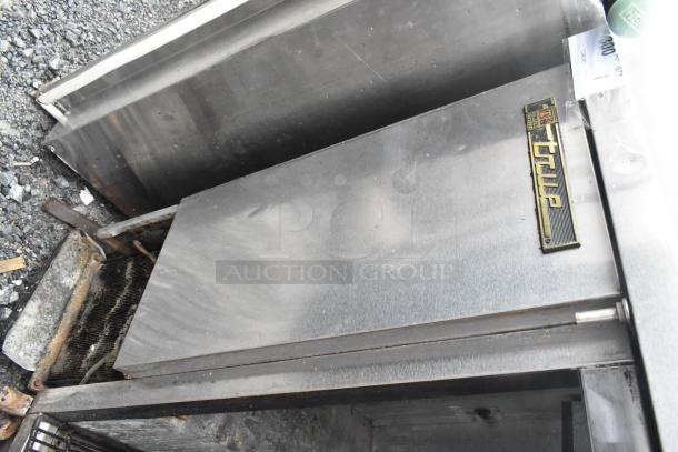 True TBB-2G-S stainless steel commercial back bar cooler, missing door, worn condition, visible True logo, 115 volts, 1 phase.