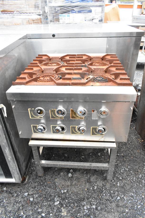 Stainless steel commercial 4 burner gas range on equipment stand, featuring heavy-duty knobs and durable construction, used condition.