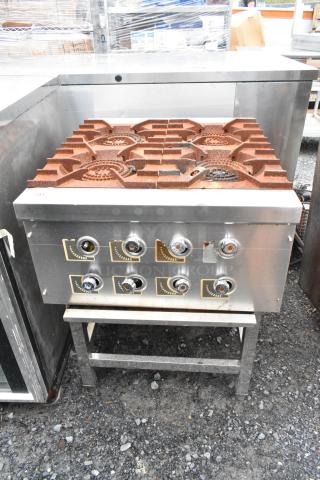 Stainless steel commercial 4 burner gas range on equipment stand, featuring heavy-duty knobs and durable construction, used condition.