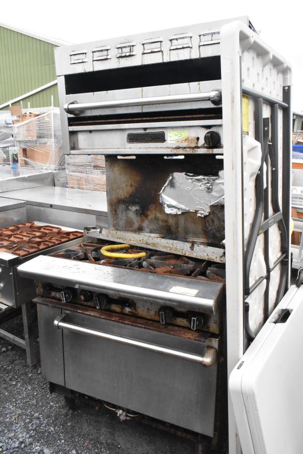 Stainless steel commercial gas 6-burner range with salamander cheese melter, backsplash, and oven. Shows signs of use.