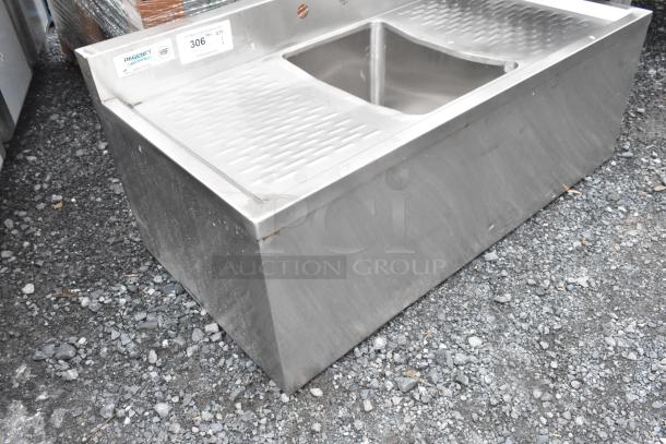 Stainless steel Regency 600B11014213 back bar sink with dual drain boards, no legs. Features label with model and NSF certification.