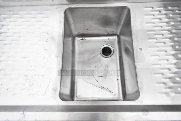 Regency 600B11014213 stainless steel back bar sink, single bay, dual drain boards, no legs, visible wear, no tags.