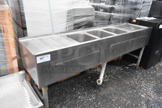 Stainless steel 3 bay back bar sink with dual drain boards, pre-owned. Condition shows signs of usage. Label: 307 QTY.